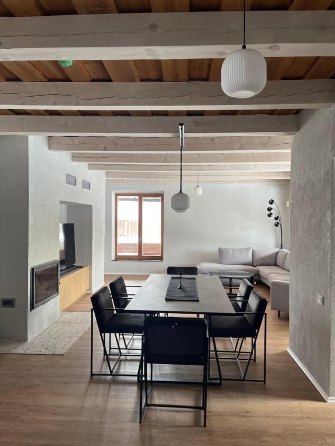 Bendra erdvė su svetaine, valgomuoju ir panoraminiais langais